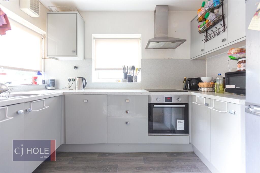 Bright and modern kitchen featuring ample count...