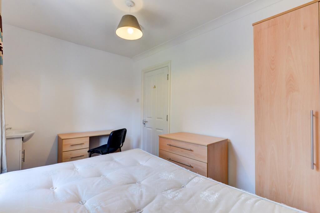 Bright and tidy double bedroom featuring a comf...