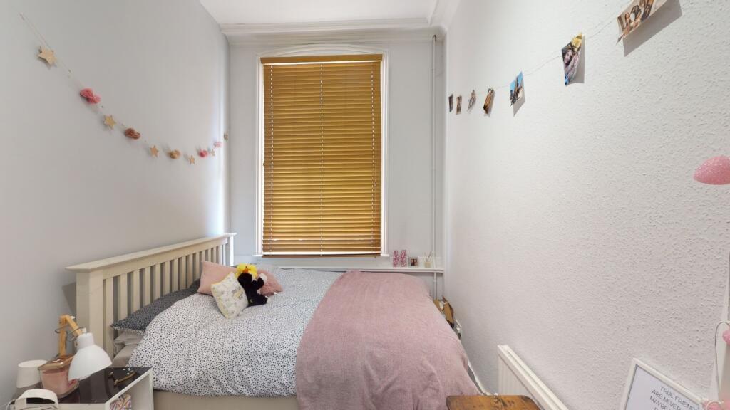 A cozy and tidy single bedroom with a comfortab...