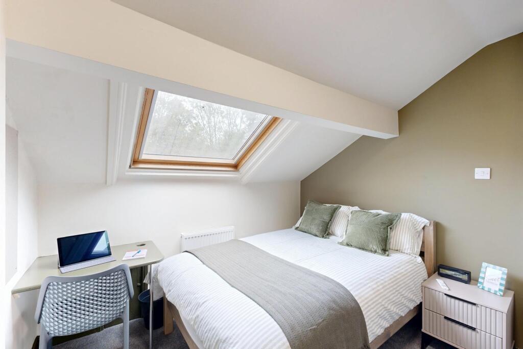 A bright and inviting bedroom with a large doub...