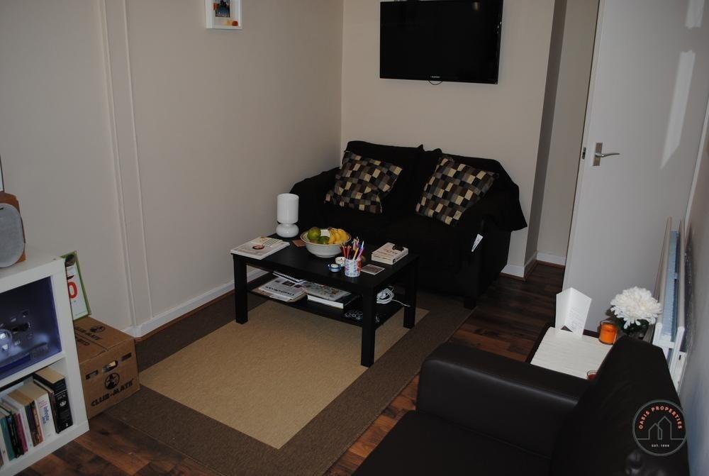 A cozy living room featuring a comfortable sofa...