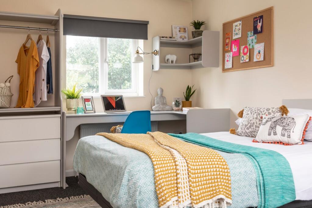 A bright and stylish bedroom featuring a neatly...