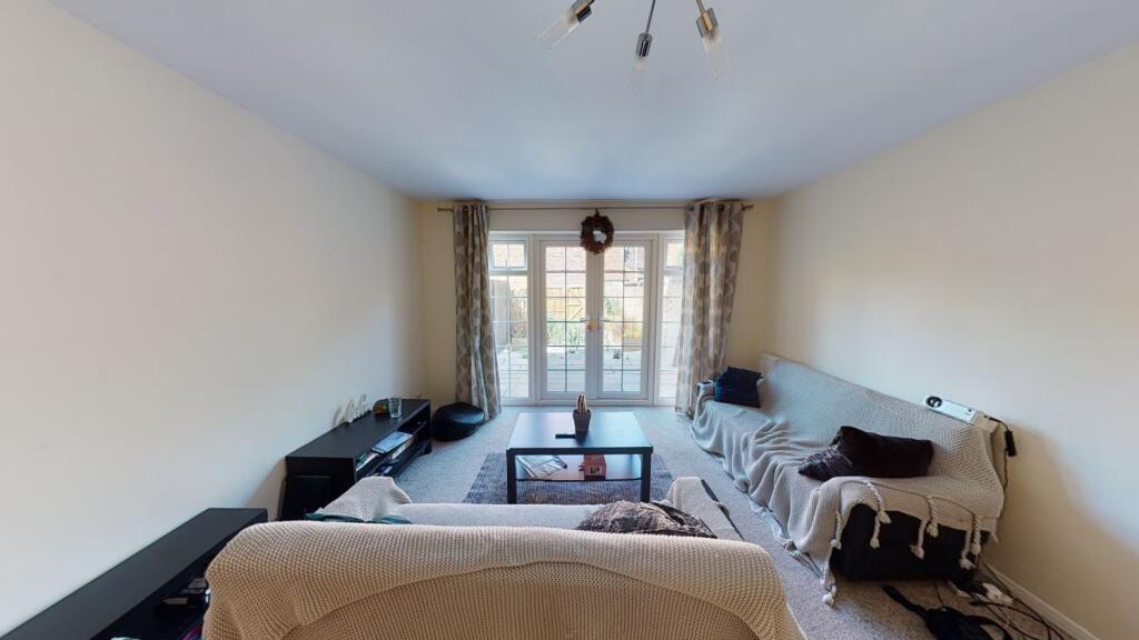 A cozy living room with a large window allowing...