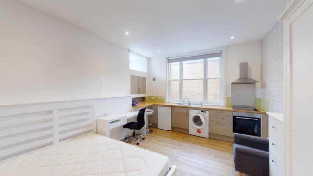 A spacious and modern kitchenette featuring amp...