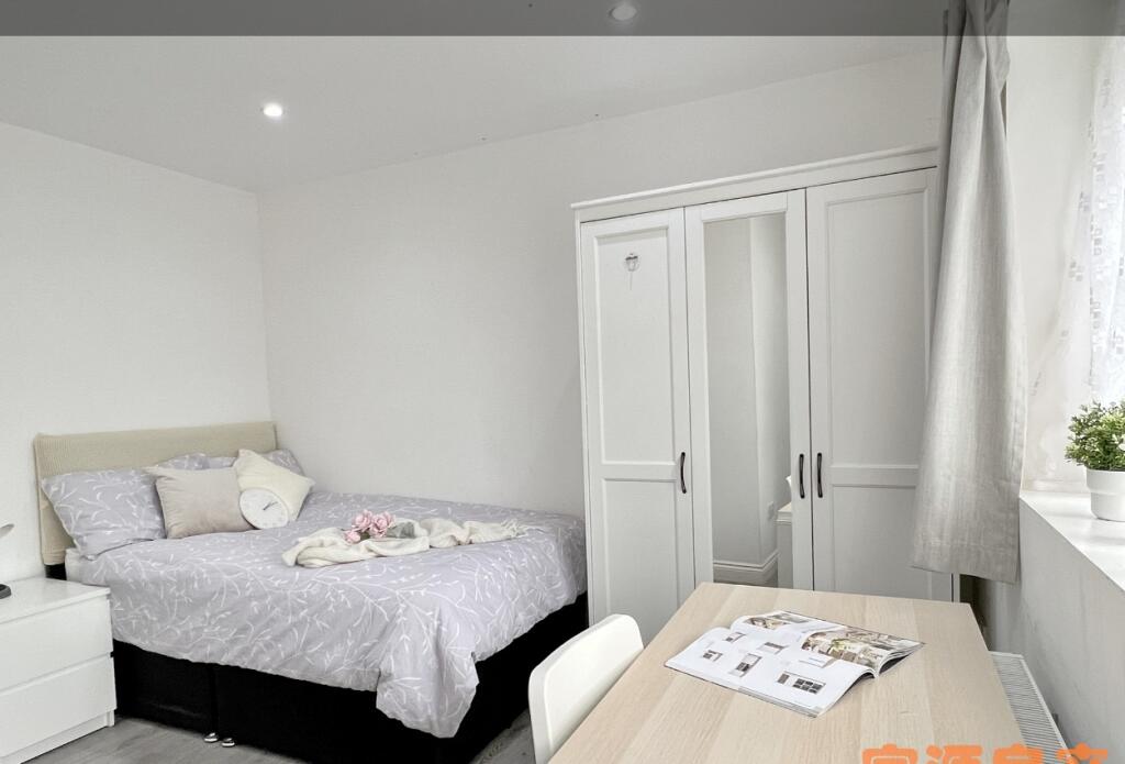 Bright and tidy double bedroom featuring a comf...