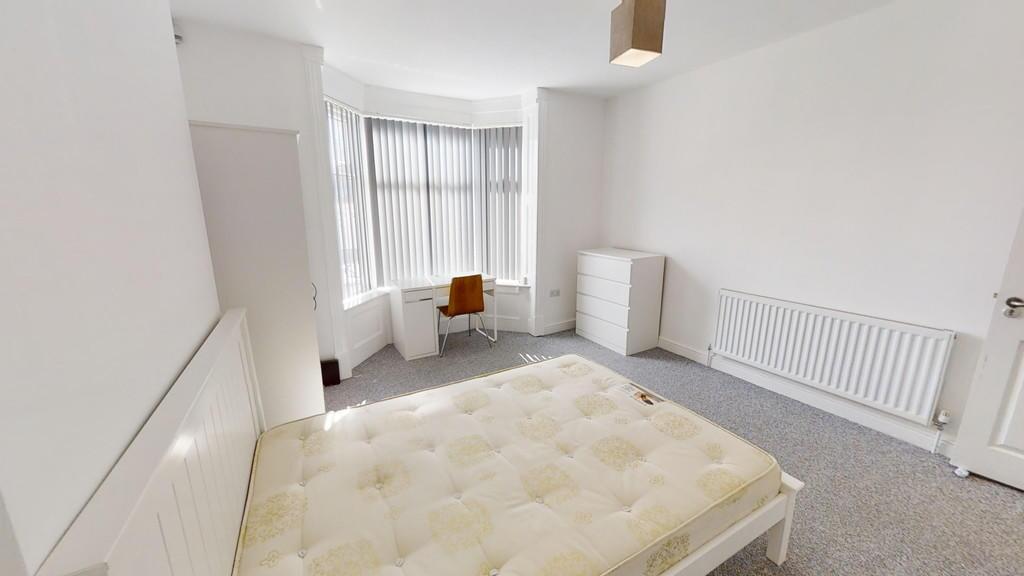 A bright and spacious master bedroom featuring ...