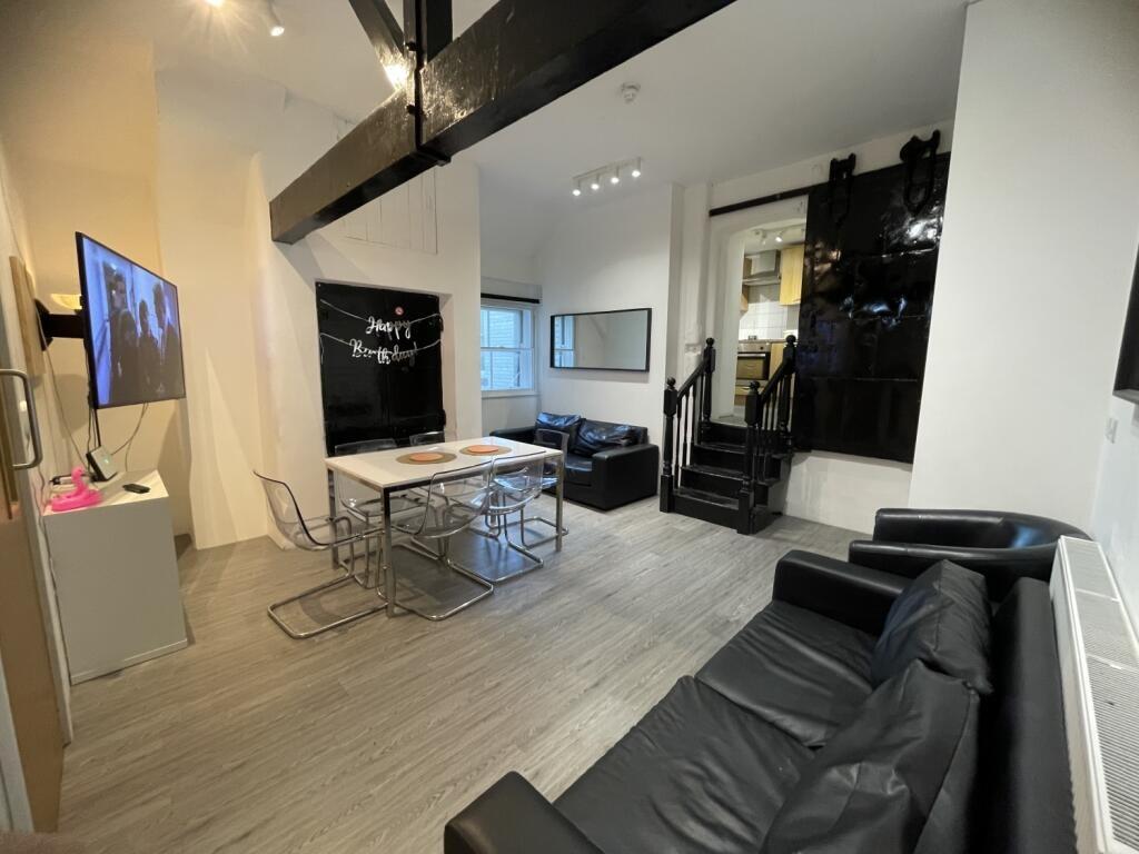 A contemporary living room featuring sleek blac...