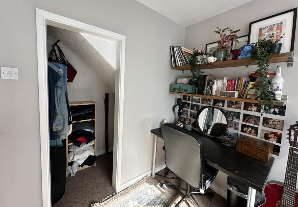 A cozy communal workspace featuring a desk and ...