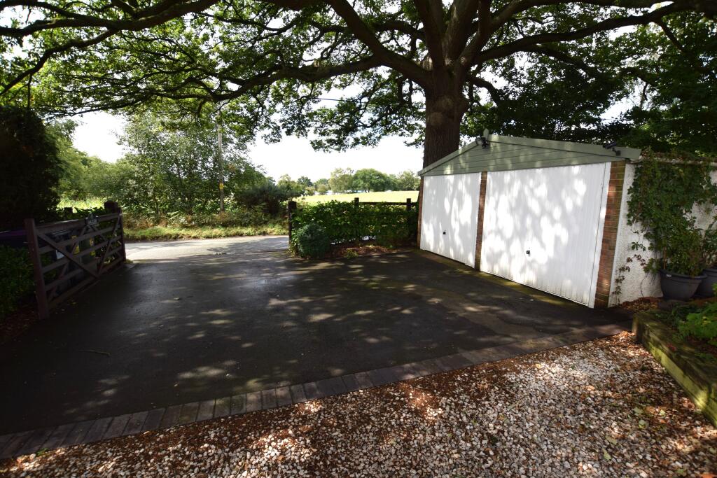 main entrance and detached double garage