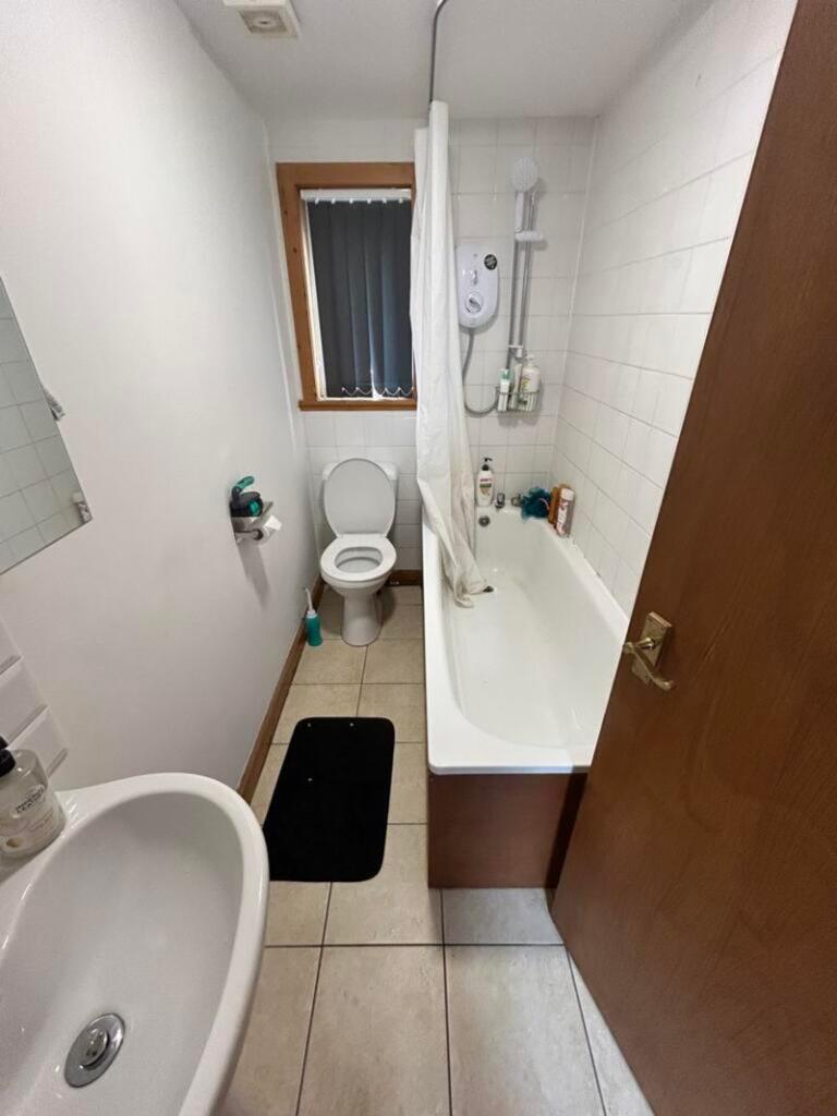 A tidy and functional bathroom featuring a bath...