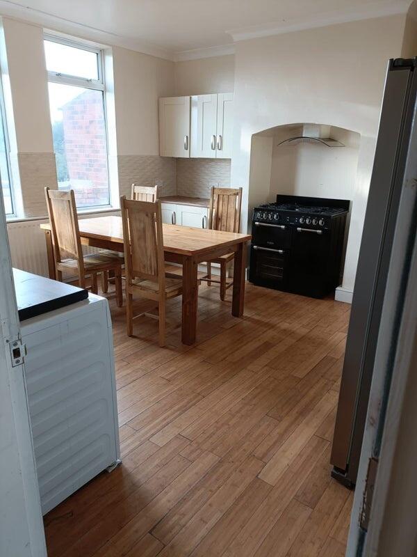 A bright and inviting kitchen featuring a woode...