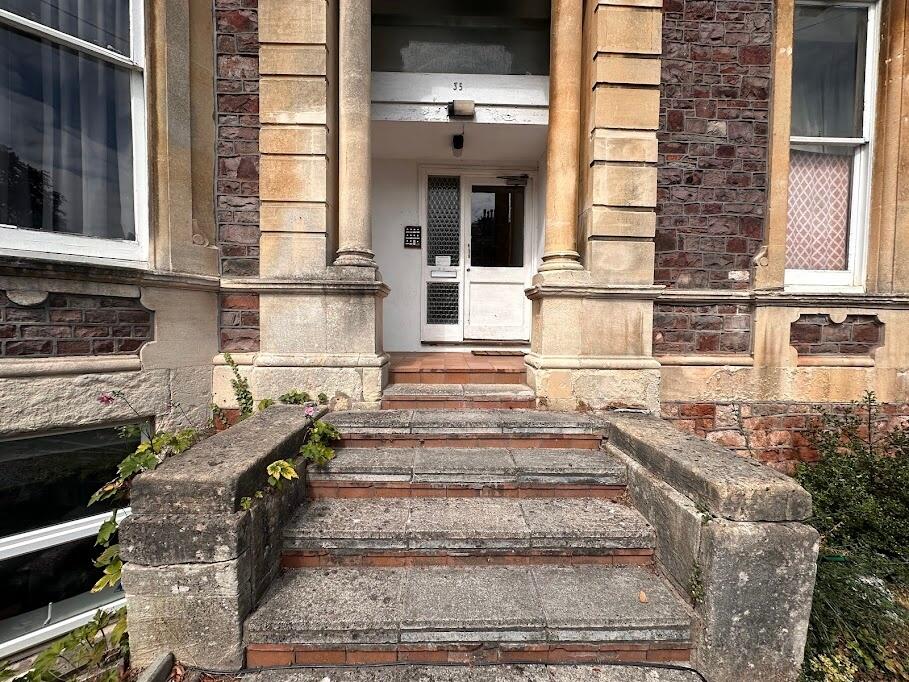 A charming entrance to a traditional stone and ...