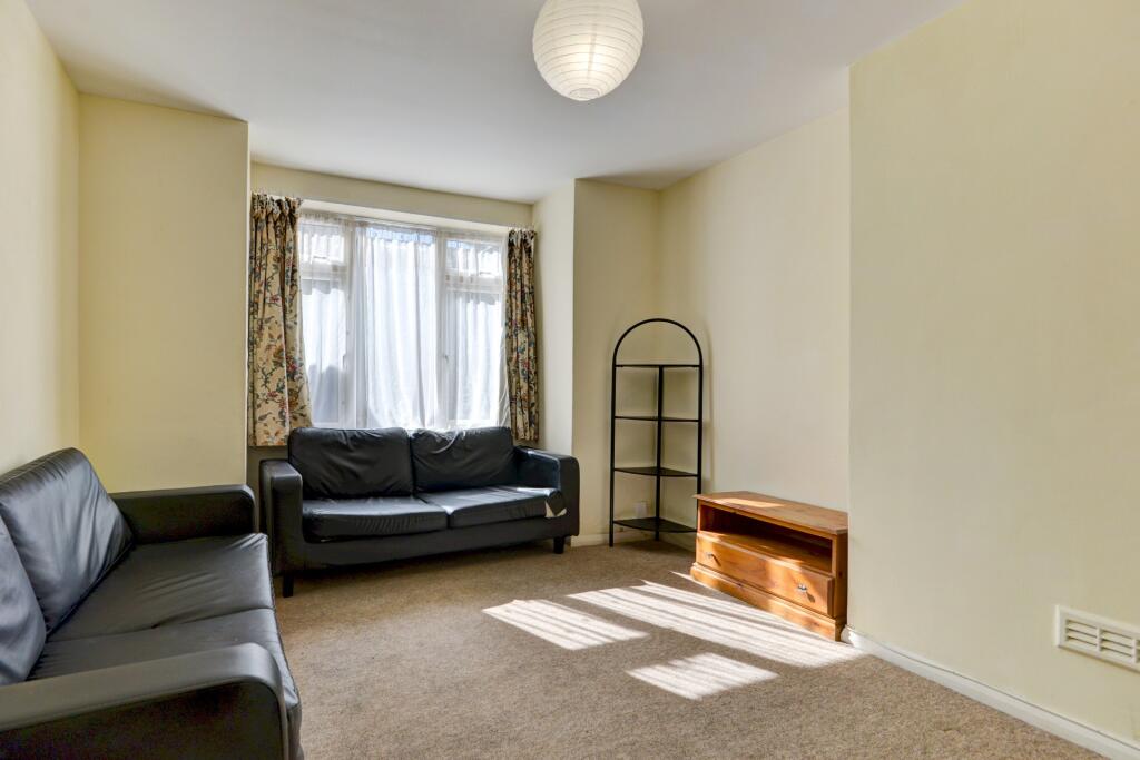 A bright and inviting living room featuring lar...