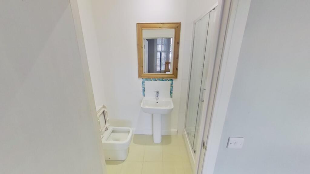 A modern and tidy bathroom featuring a clean de...