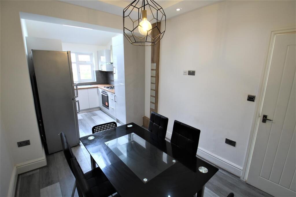 Modern kitchen and dining area featuring a slee...
