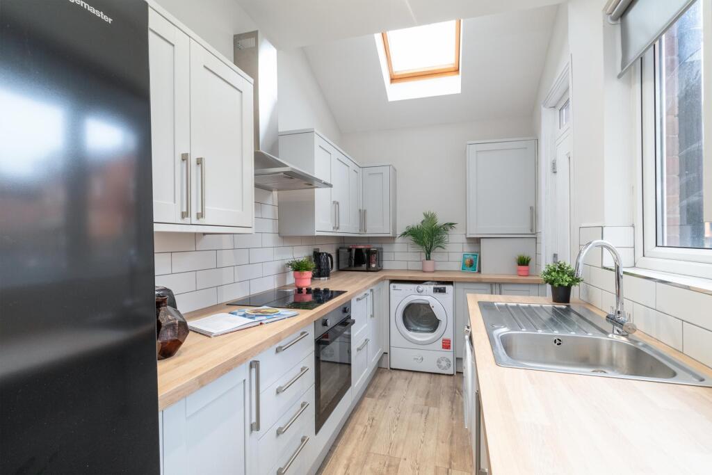 A modern, well-lit kitchen with ample counter s...