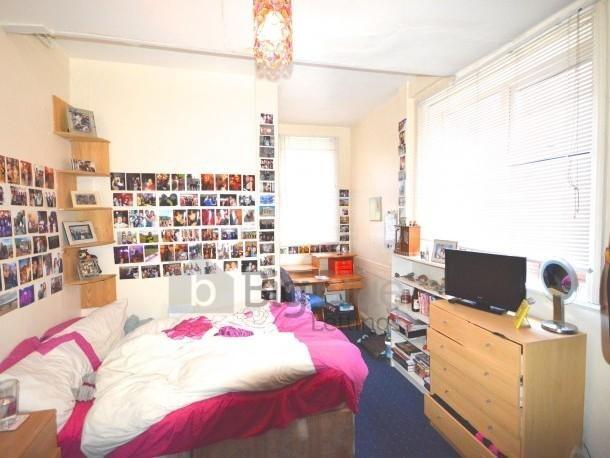 Bright and cozy single bedroom featuring a comf...