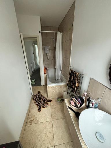 A clean and modern bathroom featuring a shower ...