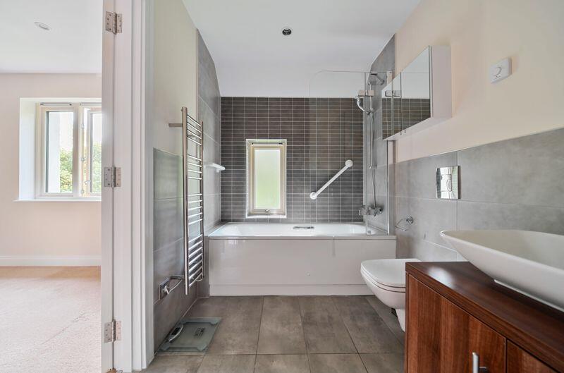 Ensuite bathroom with over-bath showe...