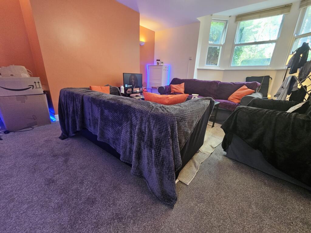 A cozy living room featuring a comfortable seat...