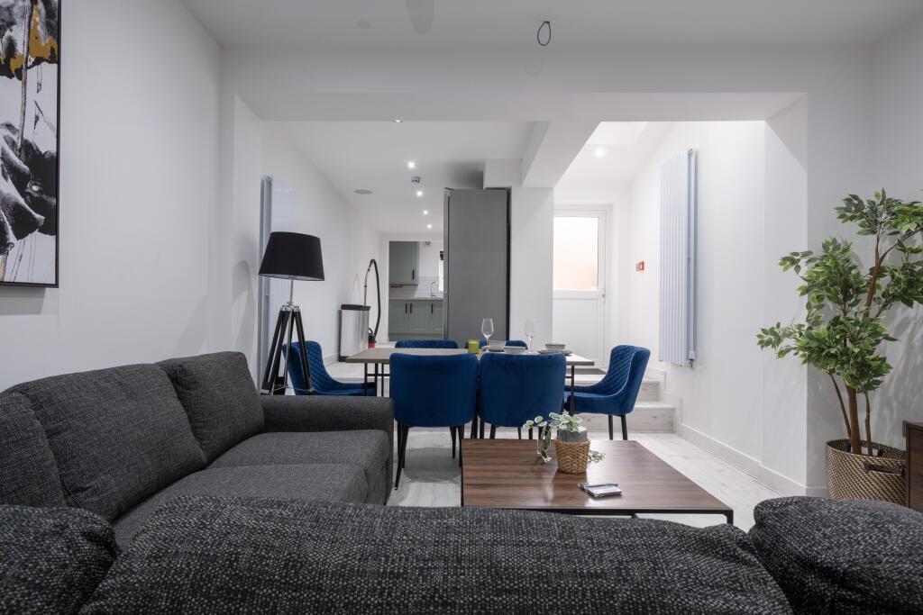 Spacious and inviting living room featuring con...