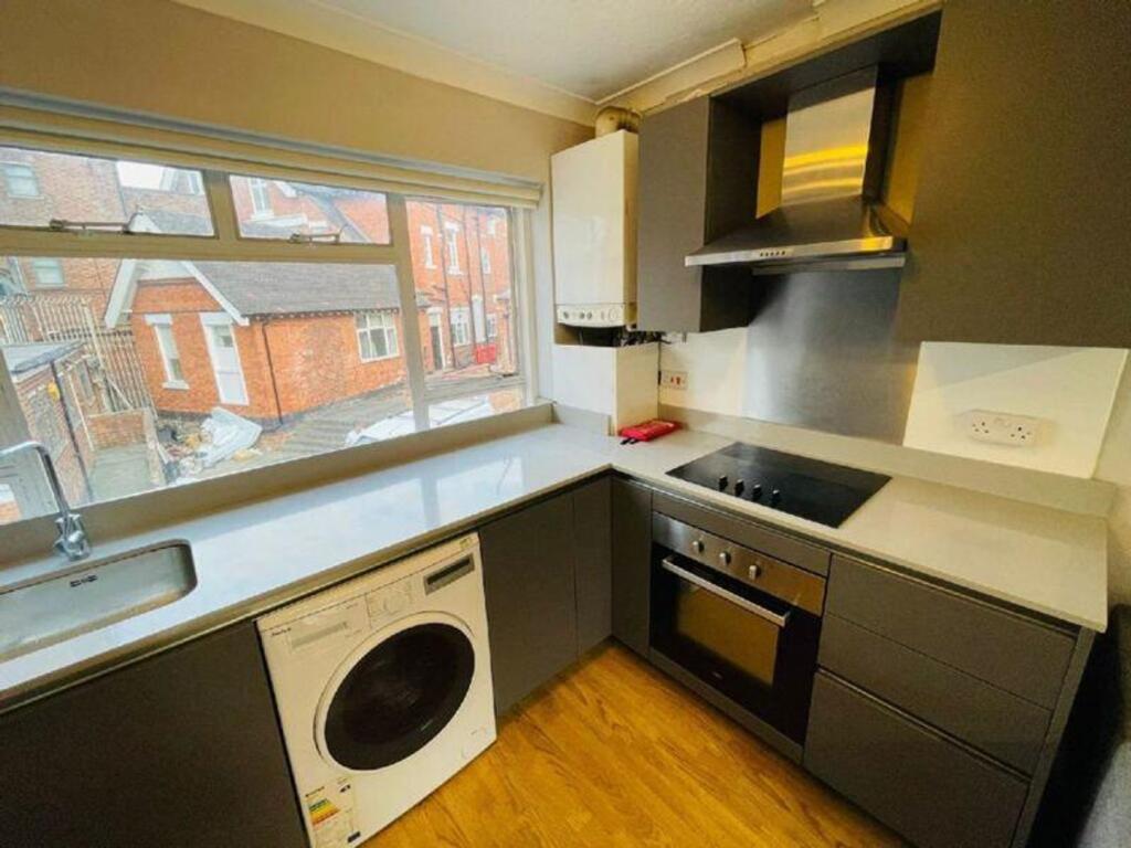 A modern and well-maintained kitchenette with a...