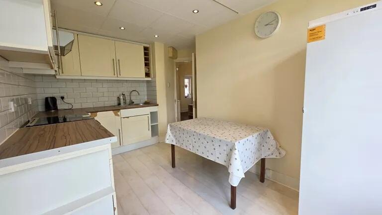 Bright and tidy kitchen featuring modern white ...