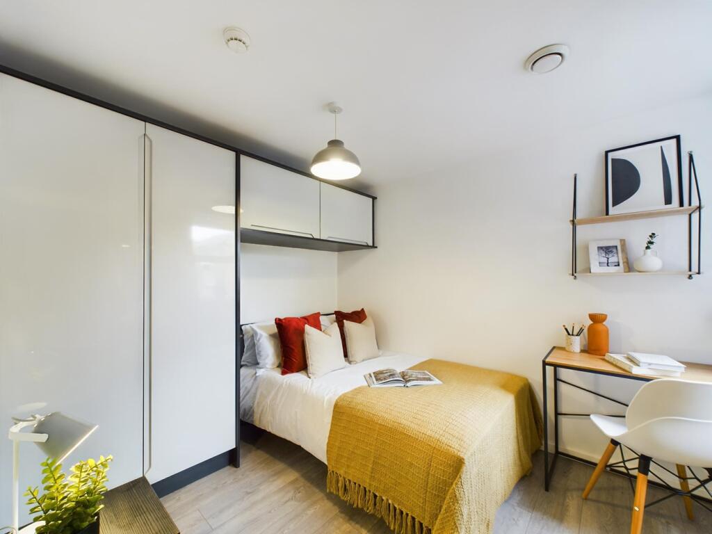 A stylish and well-lit double bedroom featuring...