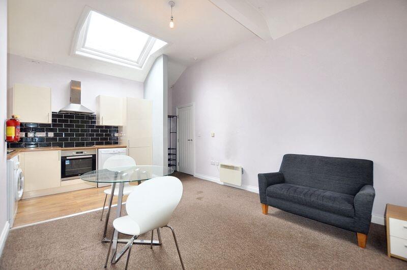 Bright and modern living space featuring a slee...