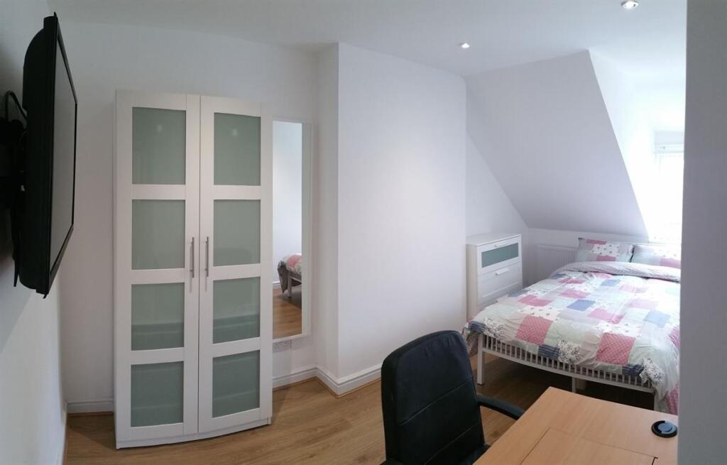 Bright, tidy bedroom with a comfortable bed, mo...