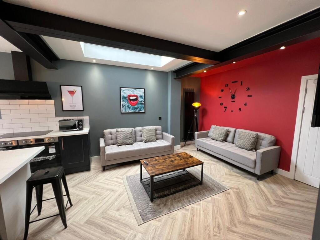 A modern, well-lit living room featuring stylis...