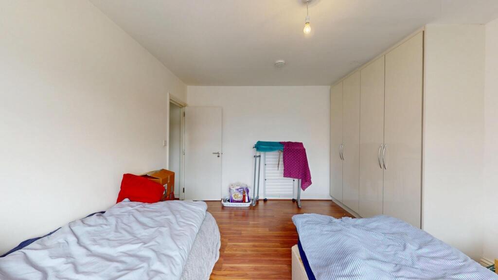 A bright and tidy double bedroom featuring two ...