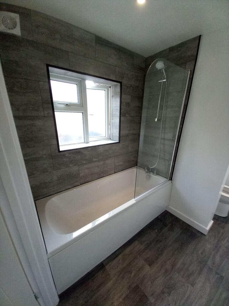 A modern bathroom suite featuring a clean white...