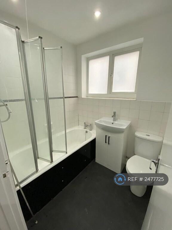 Bathroom With Electric Shower And Bath 