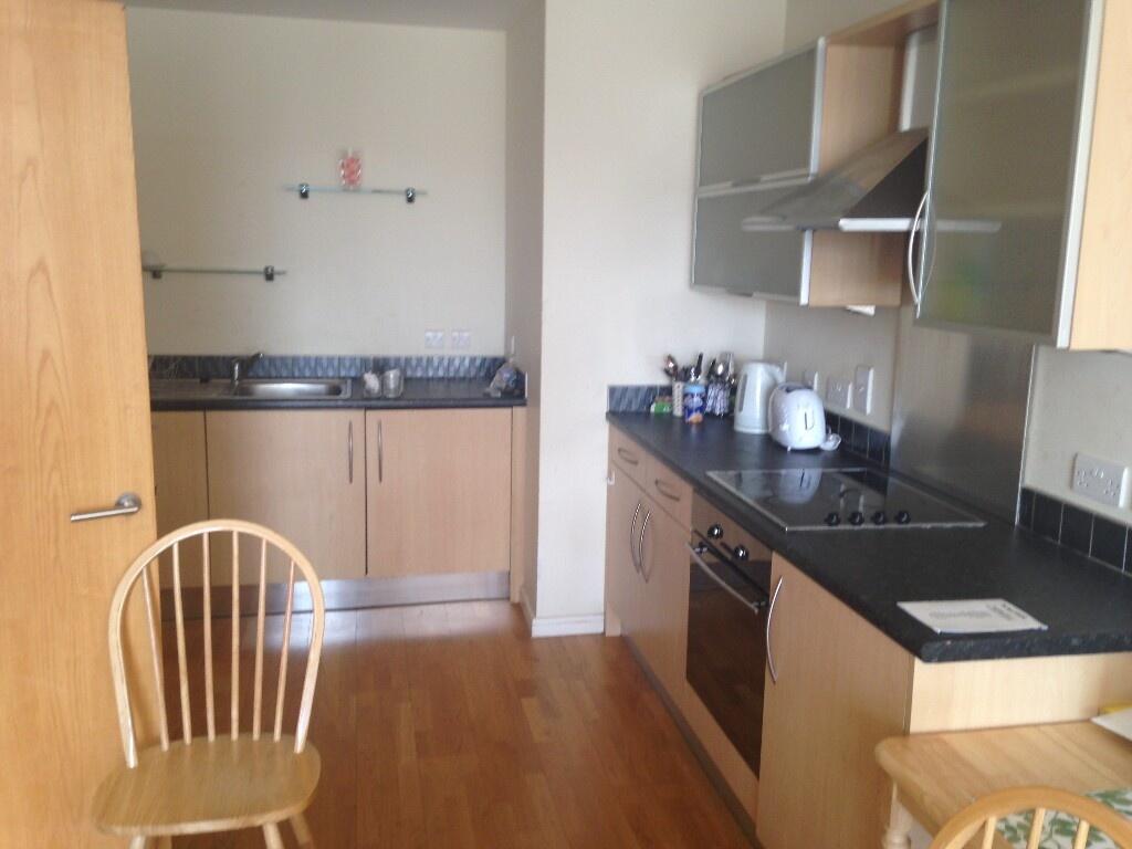 A modern kitchen featuring wooden cabinetry, bl...