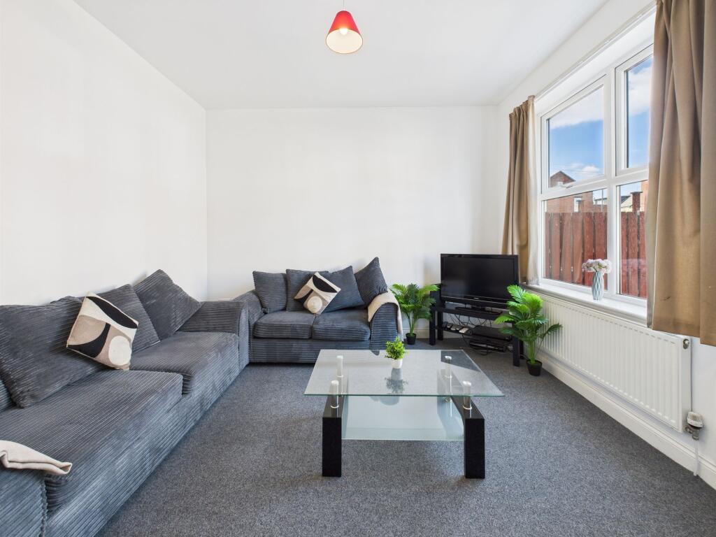 Bright and welcoming living room featuring a la...