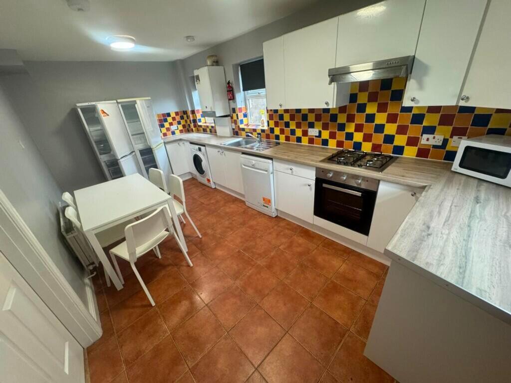 Bright and spacious kitchen featuring modern ap...