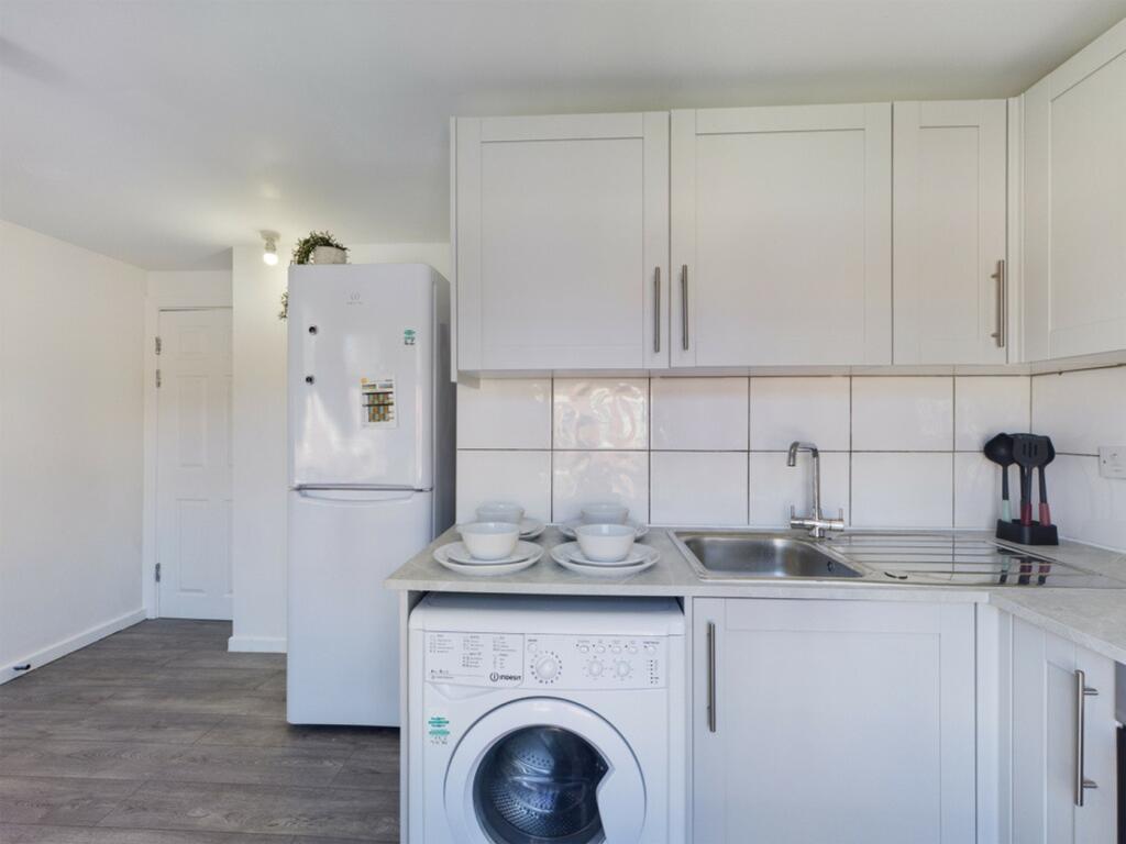 A bright and clean kitchenette equipped with mo...