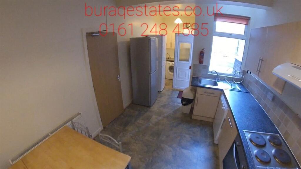 A compact kitchen featuring essential appliance...