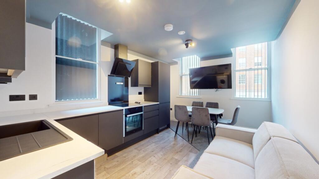 A modern and spacious kitchenette featuring lar...