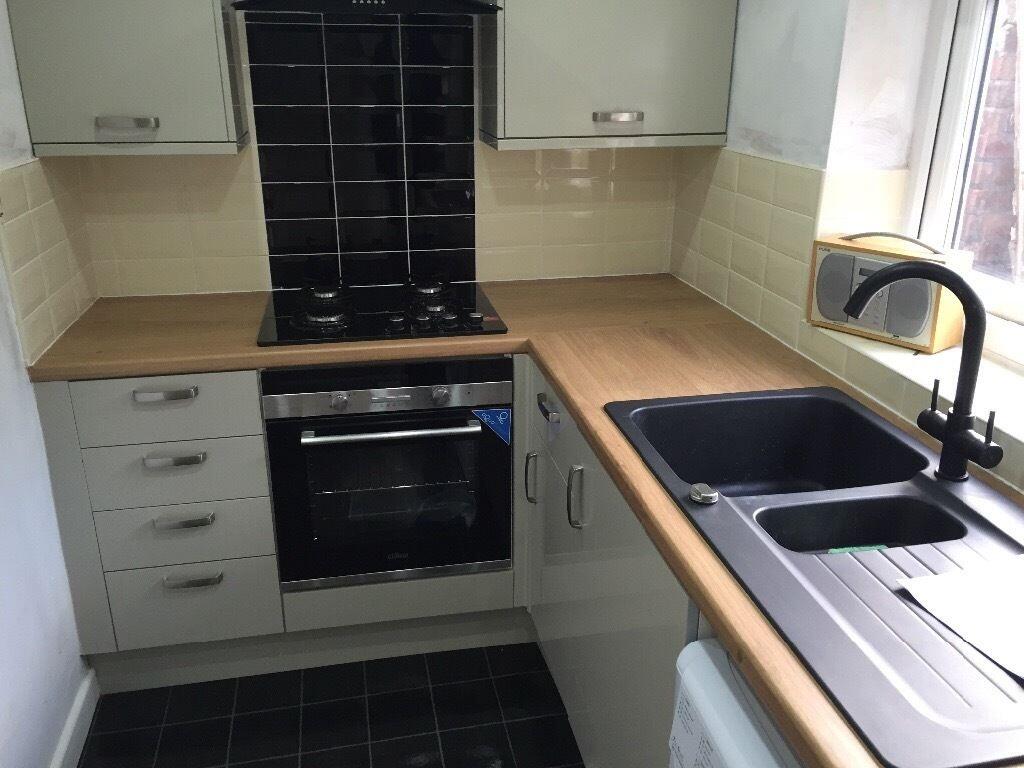 A modern kitchen featuring sleek cabinetry, a b...