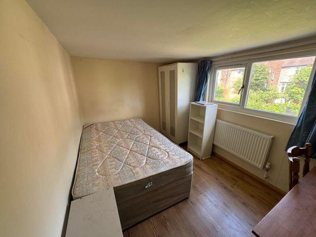 A bright and inviting double bedroom featuring ...