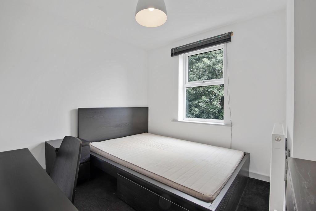 Bright and neat single bedroom featuring a comf...