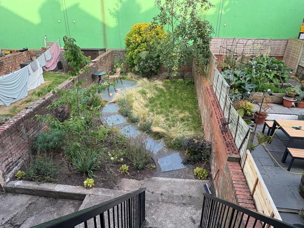 A charming and well-maintained garden space fea...