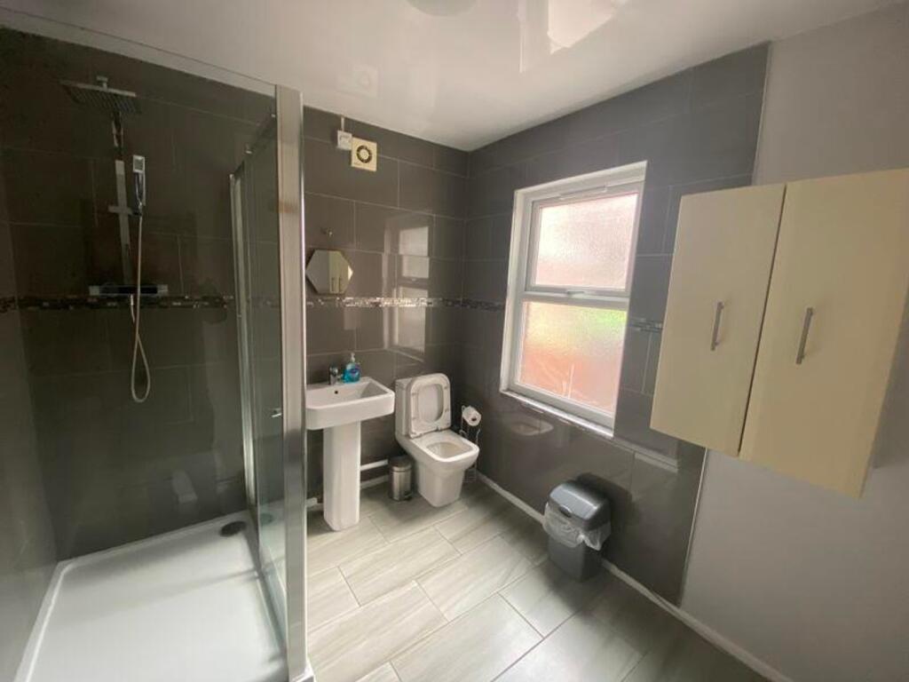 A modern and tidy bathroom featuring a spacious...