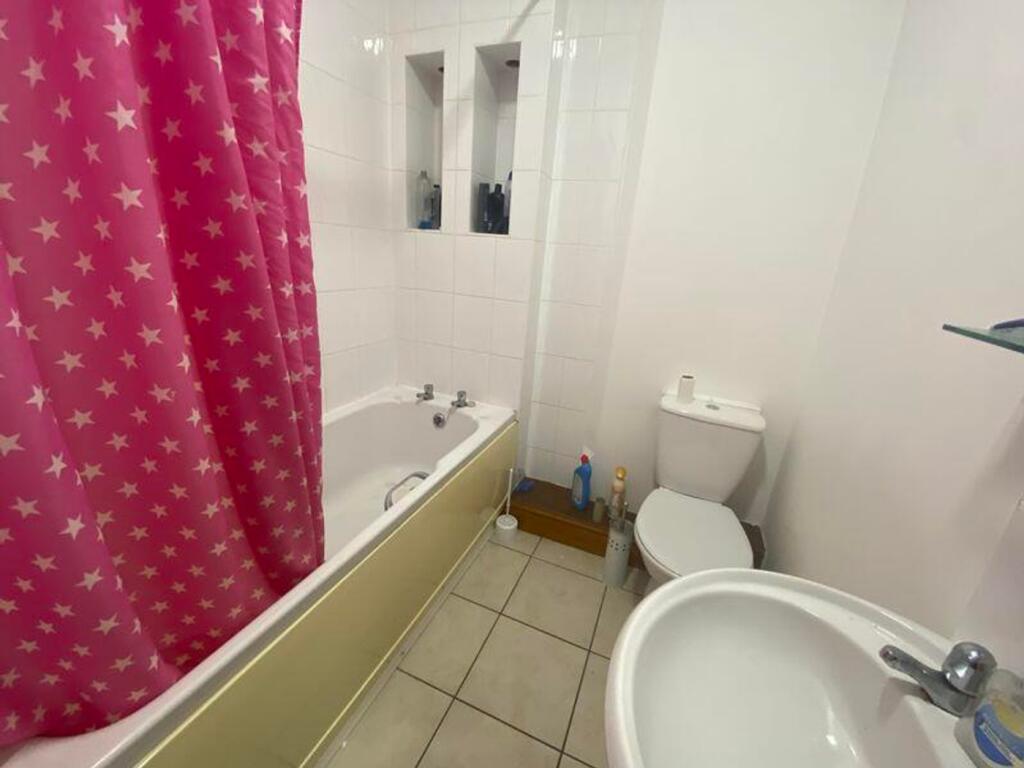 A bright and tidy bathroom featuring a charming...