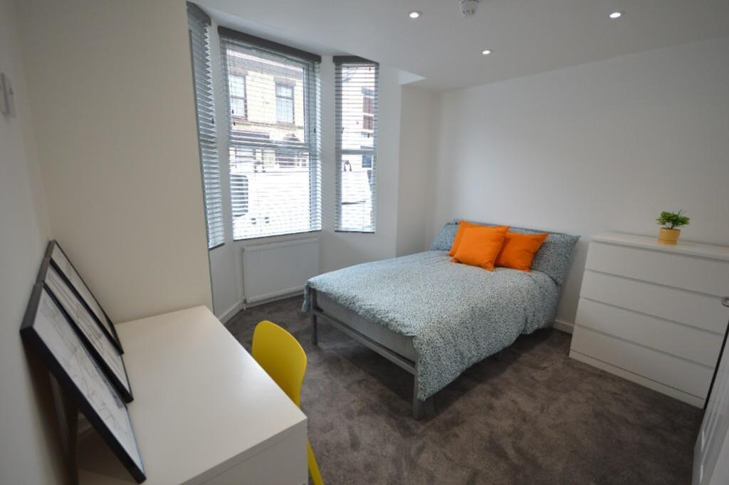 Bright and cozy double bedroom featuring modern...
