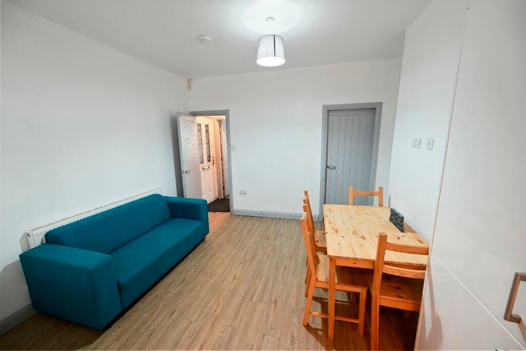 A modern living room featuring a teal sofa and ...