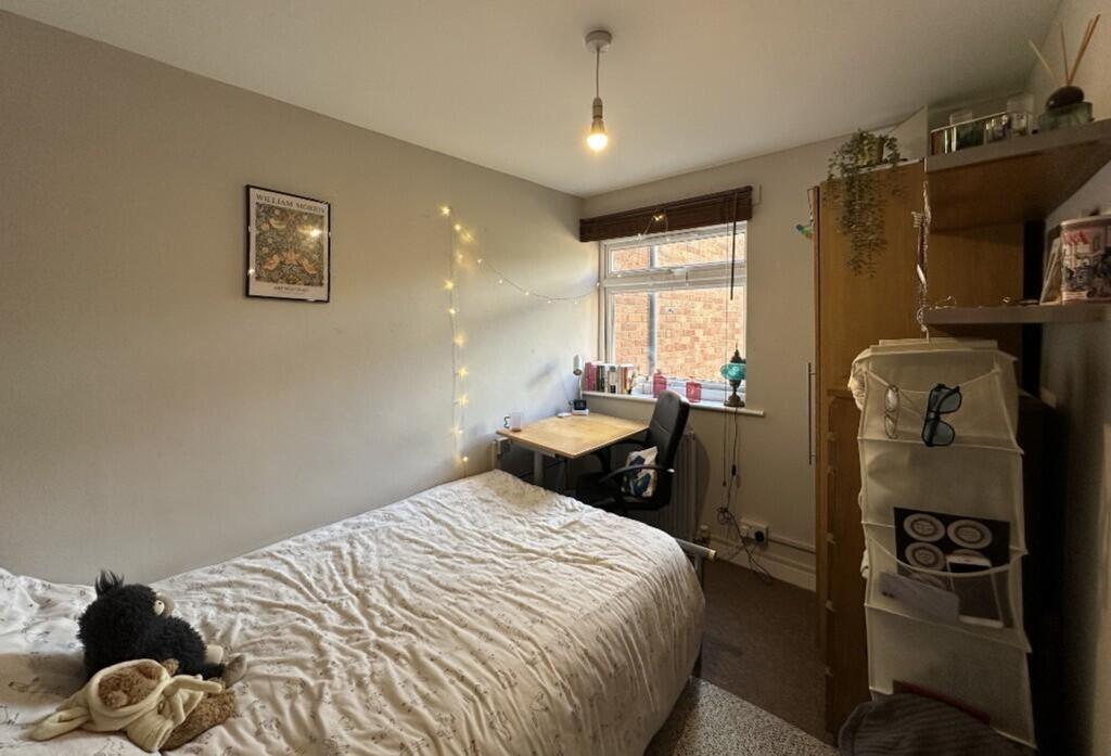 This charming double bedroom features ample nat...