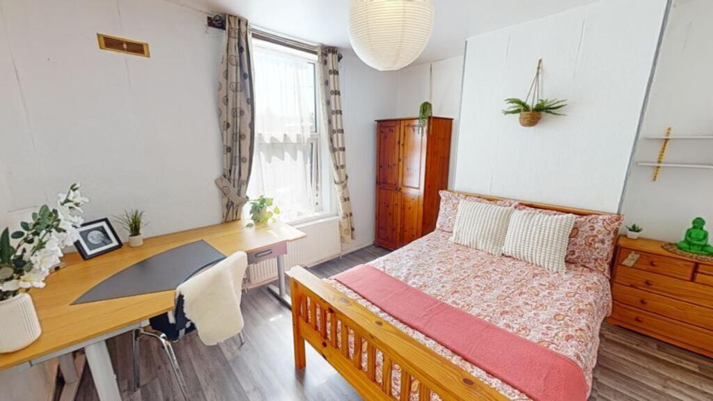 A bright and inviting double bedroom with a coz...